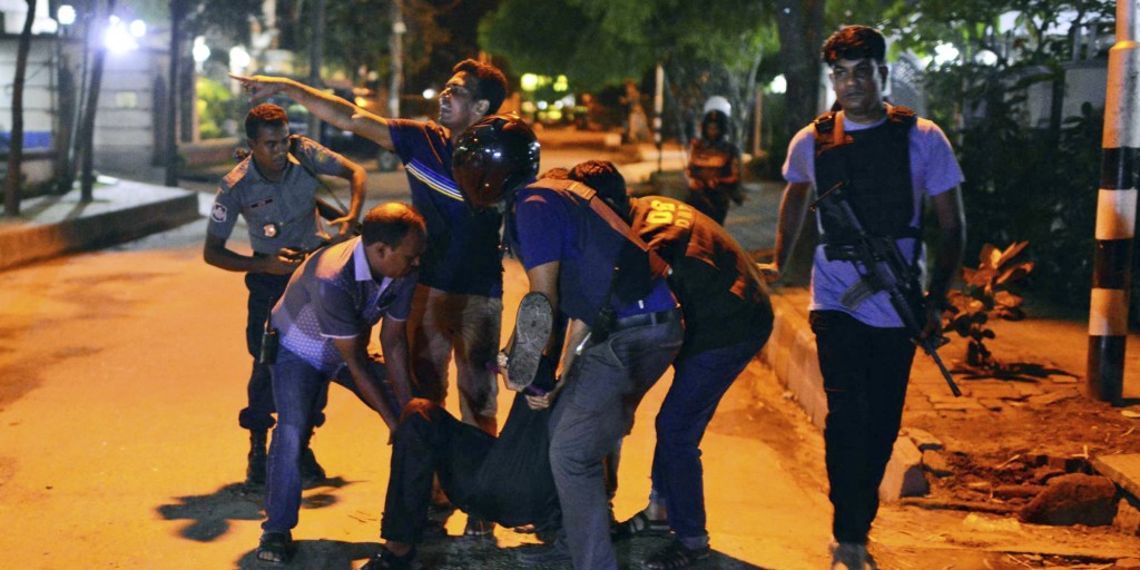 People help an unidentified injured person after a group of gunmen attacked a restaurant popular with foreigners in a diplomatic zone of the Bangladeshi capital Dhaka, Bangladesh, Friday, July 1, 2016. A group of gunmen attacked a restaurant popular with foreigners in a diplomatic zone of the Bangladeshi capital on Friday night, taking hostages and exchanging gunfire with security forces, according to a restaurant staff member and local media reports. (AP Photo)