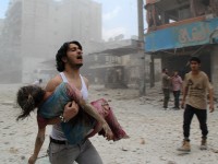 A man carries a young girl who was injured in a reported barrel-bomb attack by government forces on June 3, 2014 in Kallaseh district in the northern city of Aleppo. Some 2,000 civilians, including more than 500 children, have been killed in regime air strikes on rebel-held areas of Aleppo since January, many of them in barrel bomb attacks. AFP PHOTO / BARAA AL-HALABI        (Photo credit should read BARAA AL-HALABI/AFP/Getty Images)