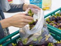 women buying fruit at supermarket