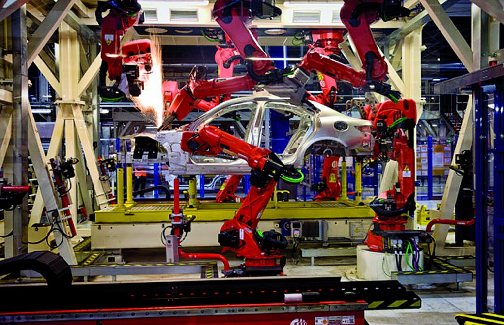 CASSINO, ITALY - NOVEMBER 24: A robot moves in the Body Shop where they assemble the Alfa Romeo Giulia and Stelvio in the Cassino Assembly Plant FCA Group. This is the most highly-automated area of the plant with nearly 1300 robots installed on  November 24, 2016 in Cassino, Italy.