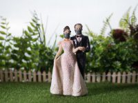 Miniature people : Happy bride wearing masks to protect against viruses during wedding time. People wear masks to prevent New type COVID-19 pneumonia. Coronavirus and Covid-19 concept. Selective focus