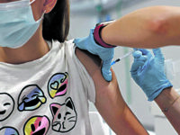epa09409455 A teenager receives a dose of a vaccine against COVID-19 at a hospital in Madrid, Spain, 11 August 2021. Madrid begins to vaccinate children over 12 years old, a measure that is already started in other Spanish regions. EPA/CHEMA MOYA