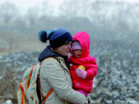 epa09807501 A Ukrainian mother holds her baby as she passes through the border crossing of Siret, northern Romania, 07 March 2022. Since Russia began its military operation in Ukraine on 24 February, some 261,445 Ukrainian citizen have entered Romania, according to the latest report of the Border Police. EPA/ROBERT GHEMENT